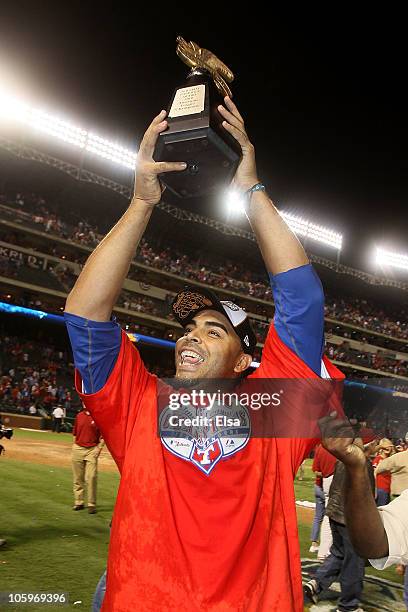 Nelson Cruz of the Texas Rangers holds the Warren C. Giles Trophy after defeating the New York Yankees 6-1 in Game Six of the ALCS to advance to the...