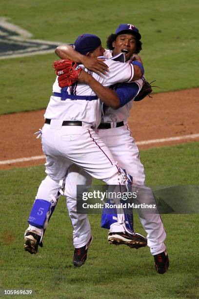 Bengie Molina and Neftali Feliz of the Texas Rangers celebrate after defeating the New York Yankees 6-1 in Game Six of the ALCS to advance to the...