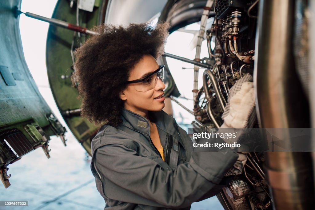 Woman repairing an aircraft