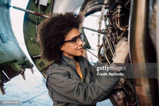 woman repairing an aircraft - mechanic uniform stock pictures, royalty-free photos & images