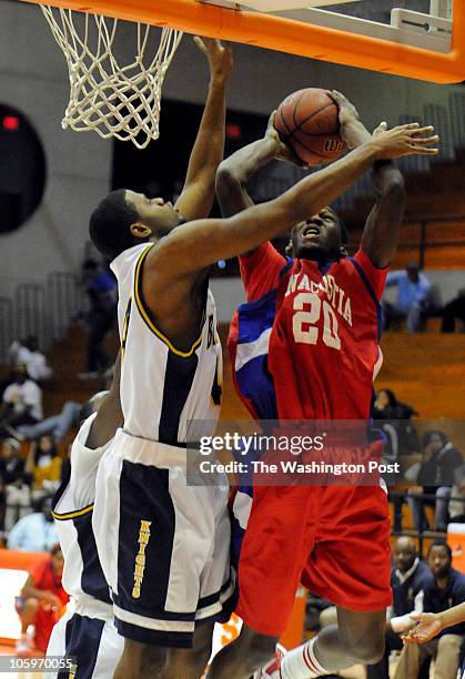 Anacostia's Junius Thomas shot over Ballou's Marquis Gentry in one of the DCIAA semifinal games at the Frank R. Williams Activity Center at Coolidge...