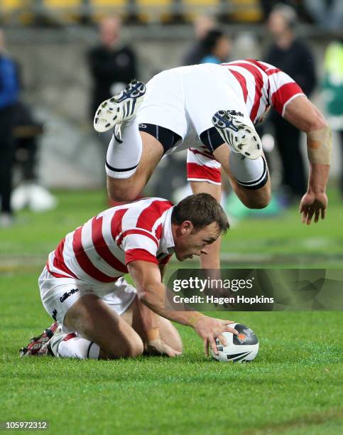 Gareth Ellis of England flies over teammate James Roby during the Four Nations match between the New Zealand Kiwis and England at Westpac Stadium on...