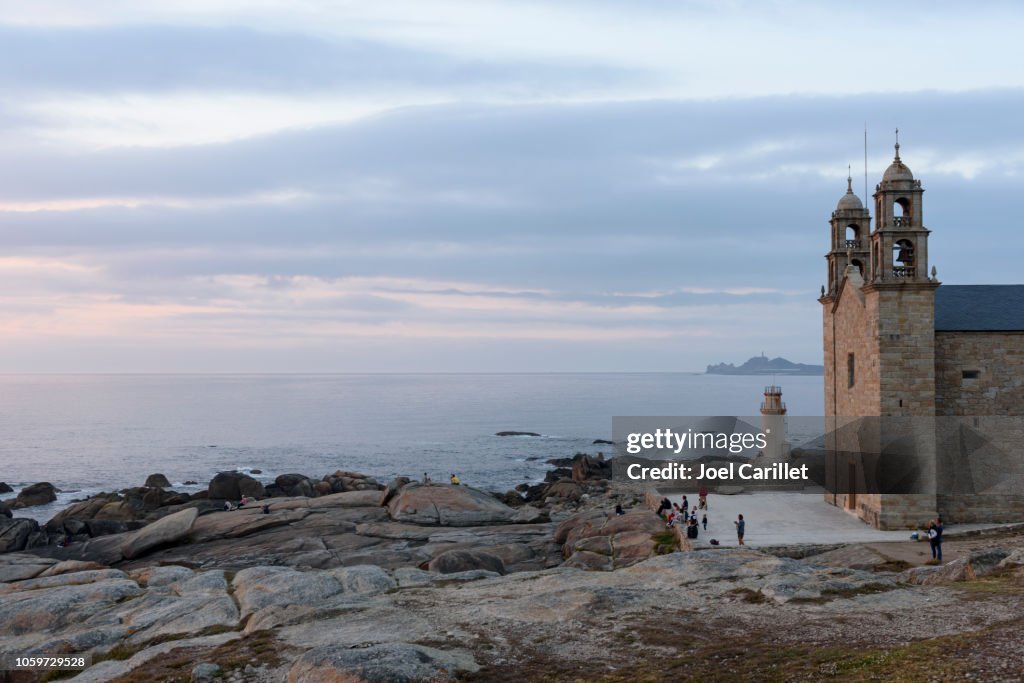 Sunset at the Virxe da Barca sanctuary in Muxia, Spain