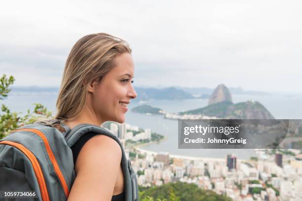 close up portrait of cheerful young woman overlooking sugar loaf mountain - gap year stock pictures, royalty-free photos & images