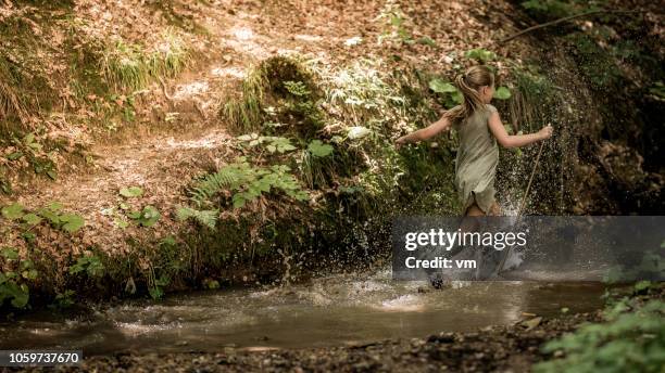 young girl in rubber boots - muddy boot stock pictures, royalty-free photos & images