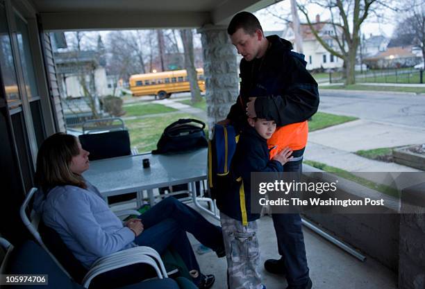 Jennifer Cline and her husband, Jason Cline say goodbye to their son Brenden Negus, moments before he is picked up by the school bus on March 23,...