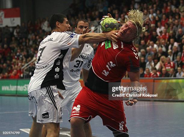 Milutin Dragicevic of Kiel challenges Bjoern Wiegers of Ahlen-Hamm during the Toyota Handball Bundesliga match between HSG Ahlen-Hamm and THW Kiel at...