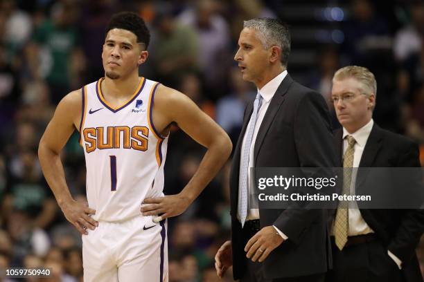 Devin Booker and head coach Igor Kokoskov of the Phoenix Suns react during the first half of the NBA game against the Boston Celtics at Talking Stick...