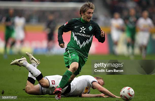 Tobias Levels of Moenchengladbach challenges Marko Marin of Bremen during the Bundesliga match between Borussia Moenchengladbach and Werder Bremen at...