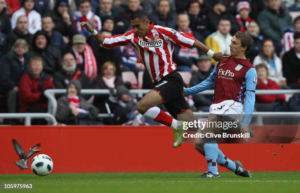 Ahmed Elmohamady of Sunderland holds off a challenge from Stephen Warnock of Aston Villa during the Barclays Premier League match between Sunderland...