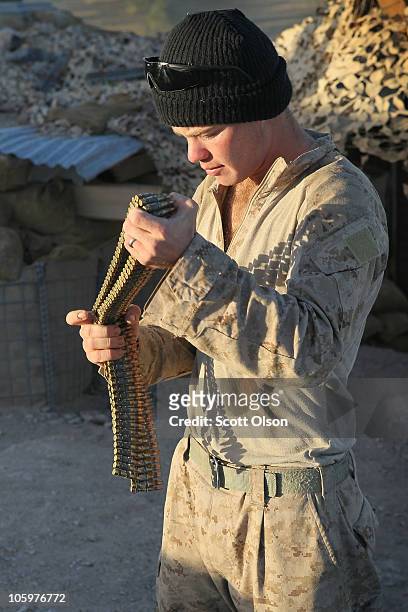 Marine Cpl. Mike Schopher of Staten Island , NY with India Battery, 3rd Battalion, 12th Marine Regiment packs up following a ten-day mission at...