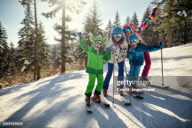 family having fun skiing - family skiing stock pictures, royalty-free photos & images