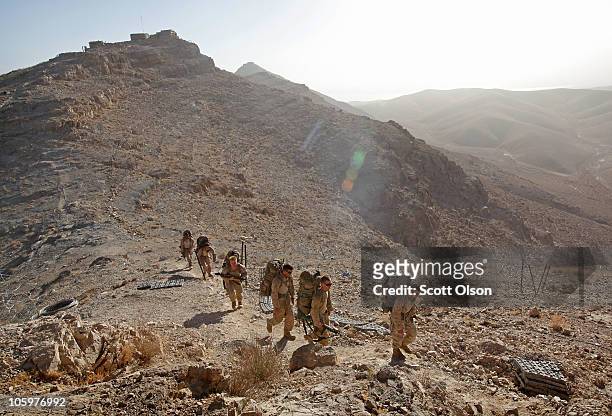 Marines with India Battery, 3rd Battalion, 12th Marine Regiment hike toward outpost West, one of the peaks above Forward Operating Base Zeebrugge, on...