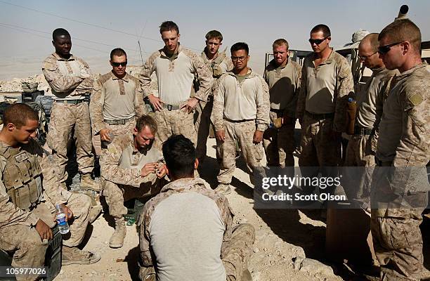 Marine squad leader Sgt. Philip Percesepe of Poughkeepsie, NY with India Battery, 3rd Battalion, 12th Marine Regiment talks to his men as they finish...