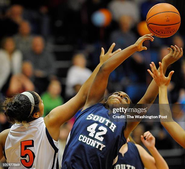 S Angela Banks grabs a rebond over West Springfield's Naomi Ngalle during West Springfield defeat of South County 37 - 24 at West Springfield High...