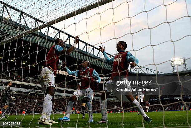 Frederic Piquionne of West Ham congratulates team mate Carlton Cole on scoring the opening goal during the Barclays Premier League match between West...