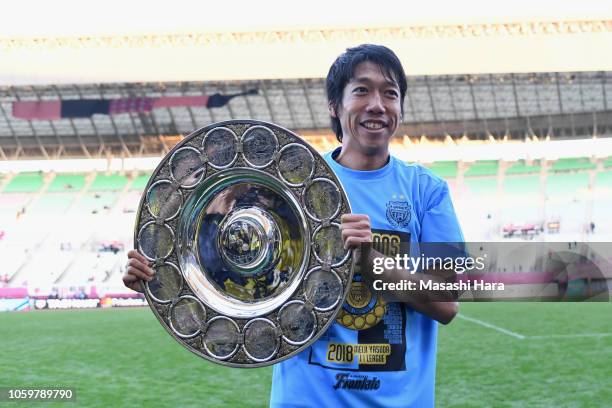 Kengo Nakamura of Kawasaki Frontale poses with the J.League Champions Schale as he celebrates his side's J1 season champions after the J.League J1...