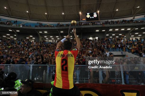 Football players of ES Tunis celebrate with a trophy after they won the CAF Champions League second leg final football match against Egypt's Al-Ahly...