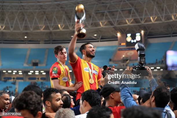 Football players of ES Tunis celebrate with a trophy after they won the CAF Champions League second leg final football match against Egypt's Al-Ahly...