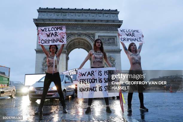 Members of feminist movement Femen demonstrate in front of the Arc de Triomphe on November 10 as several leaders are to arrive in Paris on the eve of...