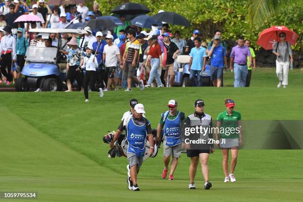 Ariya Jutanugarn of Thailand and Gaby Lopez of Mexico play a shot on the 1st hole during the final round of the Blue Bay LPGA on November 10, 2018 in...