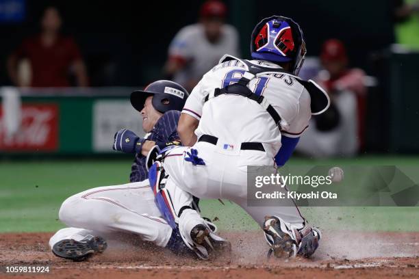 Infielder Shuta Tonosaki of Japan slides safely into the home to score a run by a two-run single by Infielder Tetsuto Yamada in the top of 7th inning...