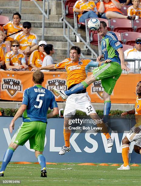 Nate Jaqua of the Seattle Sounders heads the ball away from Bobby Boswell of the Houston Dynamo in the second half at Robertson Stadium on October...
