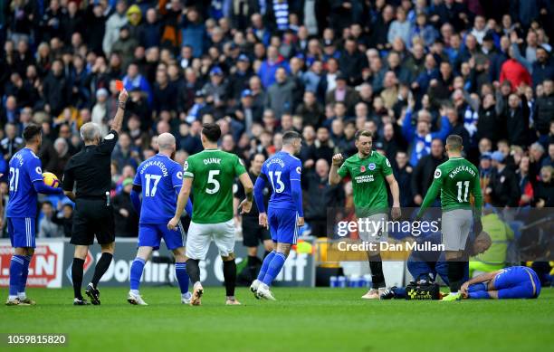 Referee Martin Atkinson shows Dale Stephens of Brighton and Hove Albion a red card during the Premier League match between Cardiff City and Brighton...