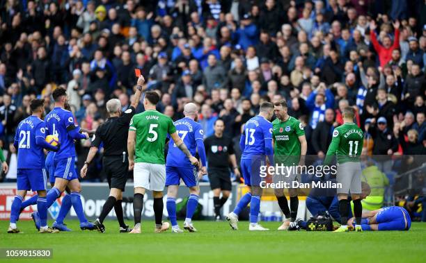Referee Martin Atkinson shows Dale Stephens of Brighton and Hove Albion a red card during the Premier League match between Cardiff City and Brighton...