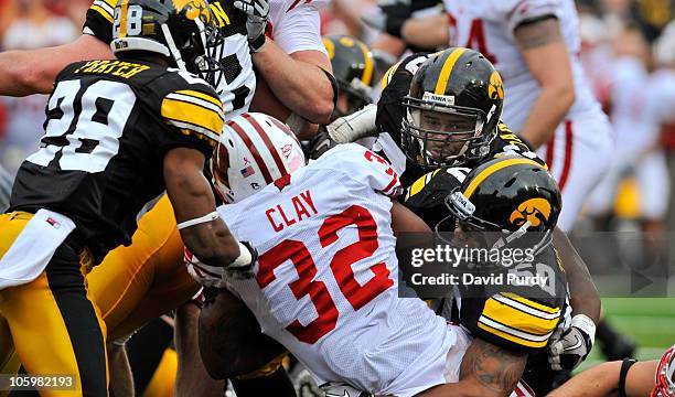 Running back John Clay of the Wisconsin Badgers breaks the goal line for a touch down as defensive back Shaun Prater, defensive lineman Mike Daniels,...