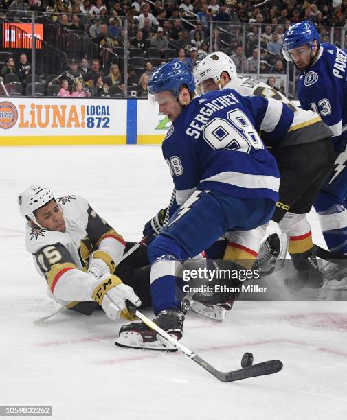 Ryan Reaves of the Vegas Golden Knights and Mikhail Sergachev of the Tampa Bay Lightning battle for the puck off the faceoff in the second period of...