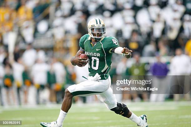 Baylor Bears quarterback Robert Griffin III slips away from Kansas State Wildcats cornerback David Garrett during an NCAA football game against...