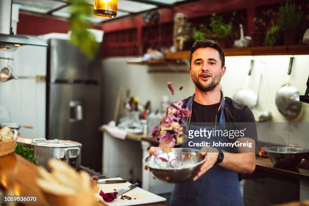 actie portret van mannelijke chef gooien ingrediënten in de kom - chef preparing food stockfoto's en -beelden