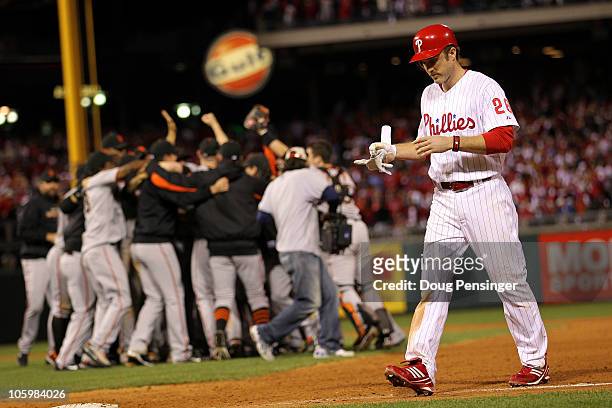 Chase Utley of the Philadelphia Phillies walks off the field as the San Francisco Giants celebrate winning 3-2 to win the pennant in Game Six of the...
