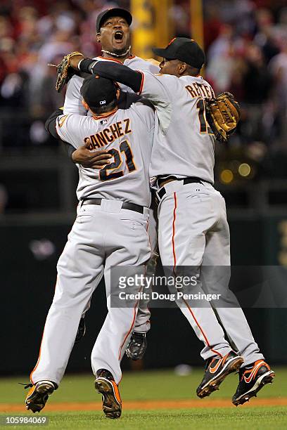 Freddy Sanchez, Juan Uribe and Edgar Renteria of the San Francisco Giants celebrate defeating the Philadelphia Phillies 3-2 and winning the pennant...