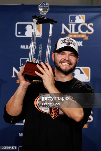 Cody Ross of the San Francisco Giants celebrates with the NCLS MVP trophy after defeating the Philadelphia Phillies 3-2 and winning the pennant in...