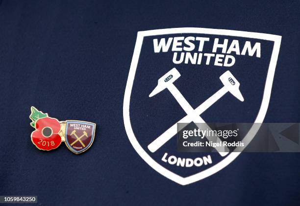 Detailed view of a pin badge, featuring the Poppy and the West Ham United crest is seen ahead of Armistice Day prior to the Premier League match...