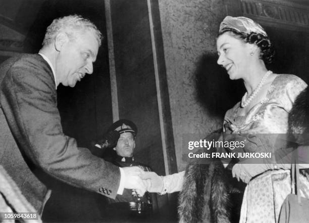 Britain's Queen Elizabeth II shakes hands with Canadian Prime Minister John Diefenbaker during a state reception at the Chateau Laurier hotel in...