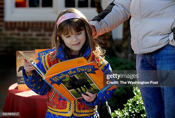 Sydney Sloat, 7 years old from Haymarket VA reads book about Molly the Pony. ÒOur goal for the foundation is something to last after me and Molly,"...