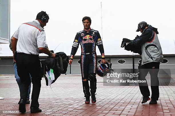 Mark Webber of Australia and Red Bull Racing walks back to the pits after crashing out during the Korean Formula One Grand Prix at the Korea...