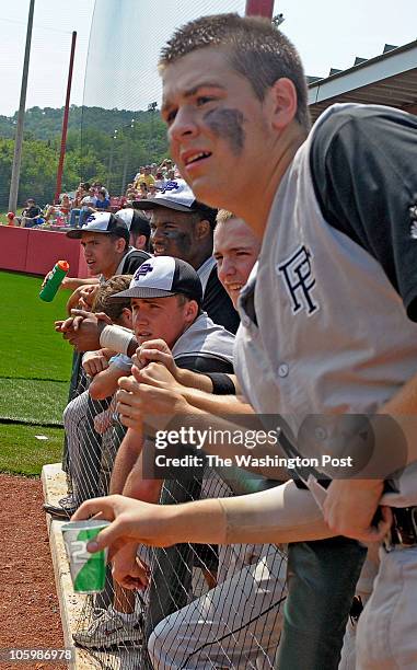 Potomac Falls dugout watches a temmate slide to second on June 13, 2010.