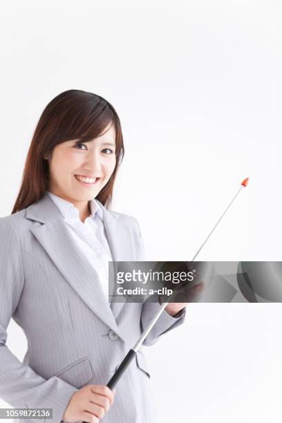 a business woman with a smile that has a stick pointing - executive smile pointing bildbanksfoton och bilder