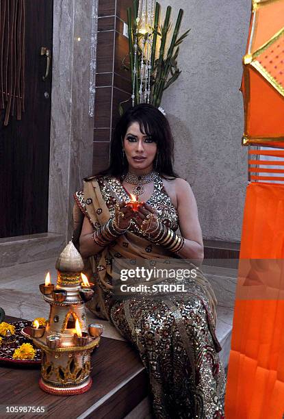 Indian Bollywood actress and producer Poonam Jhawar poses ahead of The Hindu Festival of Diwali with a colourful rangoli and candles in Mumbai late...