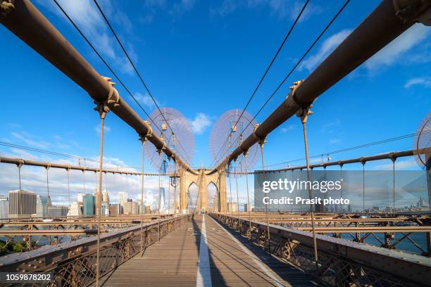 ew york city brooklyn bridge in manhattan closeup with skyscrapers and city skyline over hudson river. - ew stock pictures, royalty-free photos & images