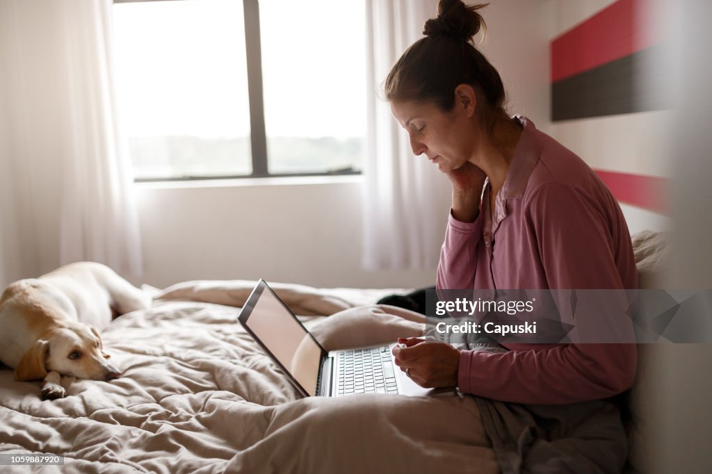 Zieke vrouw op bed videochat met je arts op laptop