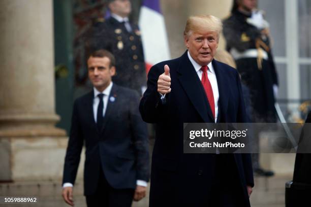 President Donald Trump gives a thumbs up as he leaves the Elysee Palace in Paris on November 10, 2018 following bilateral talks with the French...