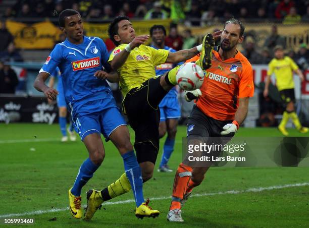 Lucas Barrios of Dortmund is challenged by Luiz Gustavo and goalkeeper Tom Starke of Hoffenheim during the Bundesliga match between Borussia Dortmund...