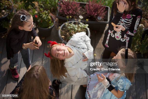 group of older children playing halloween game, shot from high angle - naughty halloween stock pictures, royalty-free photos & images