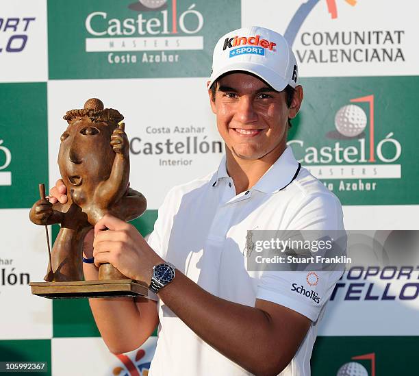 Matteo Manassero of Italy holds the trophy after winning his first professional tournament at the age of 17 after the final round of the Castello...