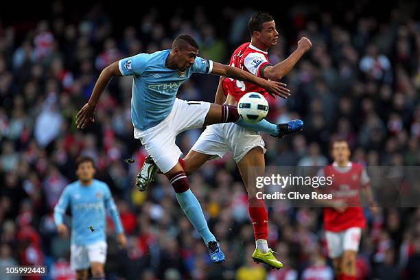 Marouane Chamakh of Arsenal is challenged by Jerome Boatang of Manchester City during the Barclays Premier League match between Manchester City and...